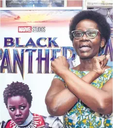  ?? BRIAN ONGORO/GETTY IMAGES ?? Dorothy Nyong’o, mother of Oscar winning Kenyan actress Lupita Nyong’o, poses in front of banners before watching the film Black Panther featuring her daughter in Kisumu, Kenya, on Tuesday.