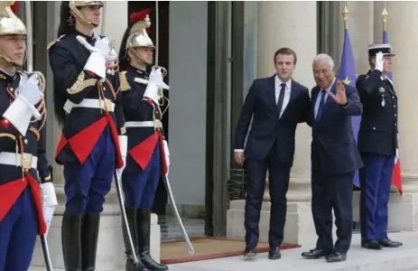  ?? MICHEL EULER/THE ASSOCIATED PRESS FILE PHOTO ?? French President Emmanuel Macron, left, welcomes Portuguese Prime Minister Antonio Luis Santos da Costa at the Élysée Palace in Paris.