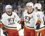  ?? Associated Press ?? Ducks defenseman Cam Fowler (center) celebrates his goal against the Arizona Coyotes with centers Adam Henrique (14) and Trevor Zegras (11) during the second period, Tuesday, in Tempe, Ariz. The Ducks won 5-2.