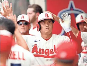  ?? JAYNE KAMIN-ONCEA/USA TODAY SPORTS ?? Shohei Ohtani is greeted in the Angels dugout after hitting a home run against the Athletics.