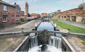  ?? PICTURES: PA / CANAL & RIVER TRUST – WATERWAYS ARCHIVE / ADOBESTOCK ?? STOP AND STAIRCASE: Main picture, engineers from the Canals & Rivers Trust replacing Britain’s tallest set of lock gates at Bingley Five Rise Locks, top left; centre, the River Ouse in York at dusk; above, the Leeds & Liverpool Canal in Leeds.