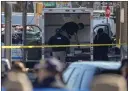  ?? JOHN MINCHILLO — THE ASSOCIATED PRESS ?? Members of the New York Police Department bomb squad examine a rental truck whose driver was arrested Monday.