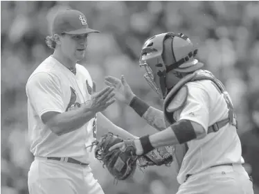  ?? Sarah Conard / The Associated Press ?? St. Louis Cardinals relief pitcher Trevor Rosenthal (left) and catcher Yadier Molina celebrate the Cardinals’ 5-3 win against the Chicago Cubs on Thursday in St. Louis. With the loss, Chicago is off to its worst start since 2002.