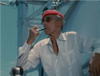  ?? ?? AT SEA: Jacques Cousteau wears his iconic red diving cap aboard his ship Calypso, in a 1970s photo from the Cousteau Society, as seen in the documentar­y ‘Becoming Cousteau.’