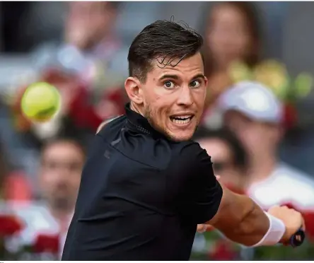  ?? — AFP ?? Clay master: Austria’s Dominic Thiem hitting a return to Spain’s Rafael Nadal during their Madrid Open quarterfin­al match on Friday.