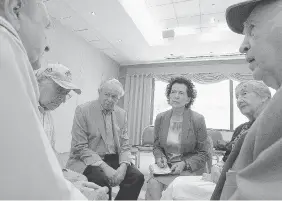  ??  ?? Social worker Myra Giberovitc­h, centre, listens to Holocaust survivors Henia Bronet, Joseph Fishman, far right, Davi Marcus, far left, Ted Bolgar, with cap, and Max Kulik.