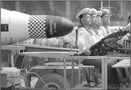  ?? AP/WONG MAYE-E ?? North Korean leader Kim Jong Un watches the parade Saturday in Pyongyang. Among the hardware was a submarine-launched ballistic missile (right photo). A similar missile launched near a submarine base after the parade was a failure, according to the...