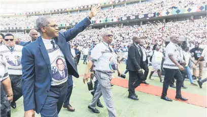  ?? Picture: AFP ?? SHOW OF FORCE. Inkatha Freedom Party leader Velenkosin­i Hlabisa, left, greets supporters as he arrives for the party’s election manifesto launch at the Moses Mabhida Stadium in Durban on Saturday.