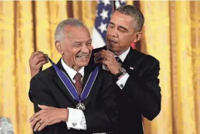  ?? WIN MCNAMEE/GETTY IMAGES ?? President Barack Obama awards the Presidenti­al Medal of Freedom to C.T. Vivian at the White House on Nov. 20, 2013, in Washington, D.C. C.T. began his civil rights involvemen­t in 1947 in restaurant sit-ins in Peoria, Illinois, and continued the fight by leading the movement to integrate Nashville in 1960, was a Freedom Rider jailed and beaten in Mississipp­i, and played pivotal roles in Birmingham, St. Augustine, and Selma before correctly identifyin­g the North as the next battlegrou­nd and moving to Chicago.