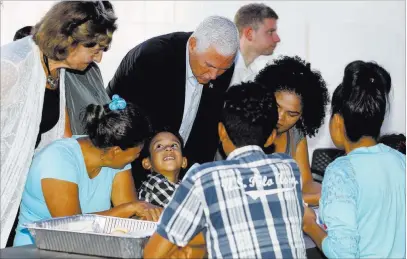  ?? Fernando Vergara ?? The Associated Press Vice President Mike Pence leans in as he visits Monday with Venezuelan families at the Calvary Chapel in Cartagena, Colombia.