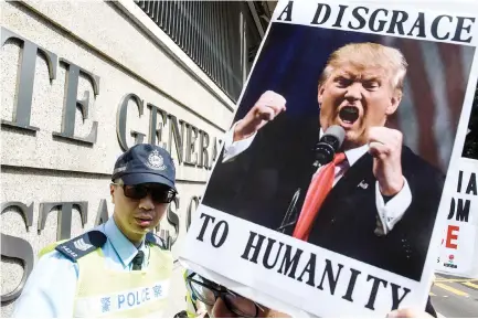  ??  ?? MEMBERS OF the League of Social Democrats of pro-democracy party and other activists take part in a protest against US President Donald Trump and his recent immigratio­n and refugee restrictio­ns, outside the US consulate in Hong Kong on Feb. 1.