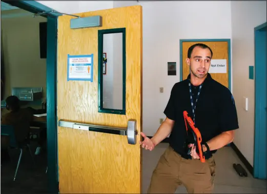  ?? WADE VANDERVORT ?? Chris Batterman, a coordinato­r in the Clark County School District’s office of emergency management, shows a single point of entry into Mojave High School during an April 7 walk-through of the North Las Vegas campus.