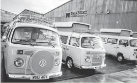  ?? GETTY IMAGES ?? Some of the last of the Brazilian-built Volkswagen Type 2 vans, converted into luxurious camper vans, are shown at Danbury MotorCarav­ans in Bristol, England.