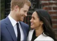  ?? MATT DUNHAM — THE ASSOCIATED PRESS FILE ?? In this file photo dated Monday Britain’s Prince Harry and his fiancee Meghan Markle pose for photograph­ers in the grounds of Kensington Palace in London, following the announceme­nt of their engagement. Speculatio­n is mounting over who will be invited...