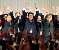  ?? AFP ?? Shinzo Abe (centre) and his party members take cheers at the end of their annual convention in Tokyo . —