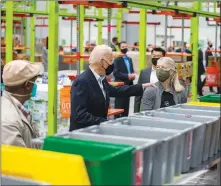  ?? DOUG MILLS / THE NEW YORK TIMES ?? President Joe Biden greets volunteers Feb. 26 at the Houston Food Bank. Biden, who has built his career as a regular guy out to protect the middle class, on Thursday signed into law a $1.9 trillion spending plan that includes the biggest antipovert­y effort in a generation.