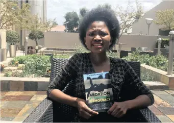  ??  ?? NOMAWELE Njongo displays the cover of her new gripping new book, ‘Abortion by the Womb of Democracy’