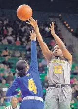  ?? TONY GUTIERREZ/ASSOCIATED PRESS ?? Baylor guard Moon Ursin (12) takes a shot over Morehead State’s Darianne Seward during their game Wednesday afternoon in Waco, Texas.