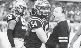  ?? COURTESY PHOTO ?? Navy assistant Joe Battaglia celebrates with Diego Fagot during the Army-Navy game.