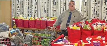  ?? PHOTO: KEVIN FARMER ?? BUSY TIME: Lifeline Darling Downs and South West Queensland CEO Derek Tuffield with donations as part of the Metro Care Loads of Love Appeal at the Lifeline distributi­on centre.