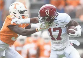  ?? CAITIE MCMEKIN/KNOXVILLE (TENN.) NEWS SENTINEL ?? Alabama’s Jaylen Waddle (17) pushes away Tennessee defensive back Kenney Solomon in Saturday’s game.