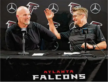  ?? CURTIS COMPTON / CCOMPTON@AJC.COM ?? With Julio Jones in the fold, coach Dan Quinn (left) began camp with messages about unity, while general manager Thomas Dimitroff (right) credited owner Arthur Blank for “taking care of our players and treating people the right way.”