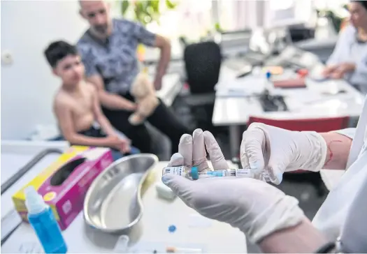  ??  ?? ABOVE
A family physician prepares a measles vaccine in Romania, where around 12,000 people have contracted the viral infecion since late 2016, with 46 deaths, making it one of the worst-affected countries in the ongoing measles outbreak in Europe.