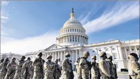  ?? AP ?? National Guard troops stand outside the US Capitol.