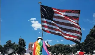  ?? PHOTO: REUTERS ?? Showing the flag . . . Americans are more nakedly patriotic than any other nation.