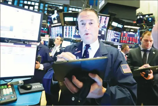  ?? (AP) ?? Trader Jonathan Corpina works on the floor of the New York Stock Exchange. Index funds now control half the US stock mutual fund market, giving the biggest funds enormous power to influence decisions and demand better returns at the companies in which they invest trillions of dollars.