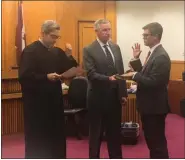  ??  ?? Danton Moyer, of Boyertown, takes the oath of office as a Montgomery County prosecutor.