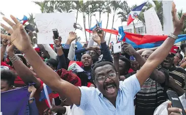  ?? — GETTY IMAGES ?? People gather near the Mar-a-Lago resort where U.S. President Donald Trump spent the last few days to condemn Trump’s reported statement about immigrants from Haiti and to ask that he apologize to them on Monday in West Palm Beach, Fla.