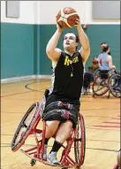  ??  ?? AT LEFT: Zach Blair of Fairborn shoots during practice with the Miami Valley Raptors wheelchair basketball team.