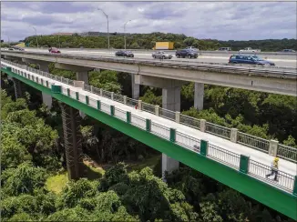  ?? JAY JANNER / AMERICAN-STATESMAN ?? The bicycle and pedestrian bridge crosses the Barton Creek gorge with a 1,045-foot-long span next to MoPac Boulevard. The trail and bridges will provide easy, protected access from Southwest Austin to Barton Springs, Zilker Park and the Butler Hike and...