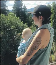  ?? CP PHOTO ?? Kori Doty holds their child Searyl in Slocan, B.C., in this recent handout photo. A parent’s request to exclude their child’s sex on government­issued identifica­tion is pushing past the boundaries of gender stereotypi­ng, experts say. Kori Doty, a B.C....