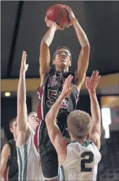  ?? NIKKI BOERTMAN/ THE COMMERCIAL APPEAL ?? ECS’ Skal Labissiere, who had 12 points and five blocked shots, shoots over Webb’s Kevin Gormley (left) and Brandon Babors during the Eagles’ semifinal Div. 2 win in Nashville.