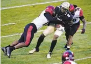  ?? DAVID ZALUBOWSKI AP ?? SDSU safety Tariq Thompson (left) and linebacker Andrew Aleki tackle Colorado receiver La’Vontae Shenault.