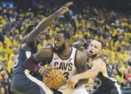  ?? MARCIO JOSE SANCHEZ ASSOCIATED PRESS ?? Cavaliers forward LeBron James, center, is defended by Warriors forward Draymond Green, left, and guard Stephen Curry during Game 2 of the NBA Finals on Sunday in Oakland, Calif.