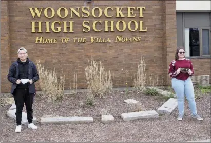  ?? Joseph B. Nadeau photos ?? Eric Lu, left, Woonsocket High School’s Class of 2020 Valedictor­ian, and Class Salutatori­an Allyson Deziel stand outside their school last week after another week of distance learning wrapped up.
