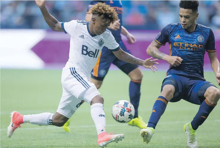  ?? — THE CANADIAN PRESS ?? Vancouver Whitecaps striker Yordy Reyna, left, tries to move the ball past New York City FC’s Alexander Callens during the second half on Wednesday.