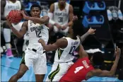  ?? MICHAEL CONROY — THE ASSOCIATED PRESS ?? Baylor guard Jared Butler (12) passes over teammate guard Adam Flagler (10) and Houston forward Justin Gorham (4) during the first half of a men’s Final Four NCAA college basketball tournament semifinal game, Saturday at Lucas Oil Stadium in Indianapol­is.