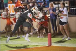  ?? Staff photo by Evan Lewis ?? Texas High wide receiver Tevailance Hunt makes sure the ball breaks the line of the end zone on his way to scoring the Tiger's first touchdown during Friday night's game against Liberty-Eylau.