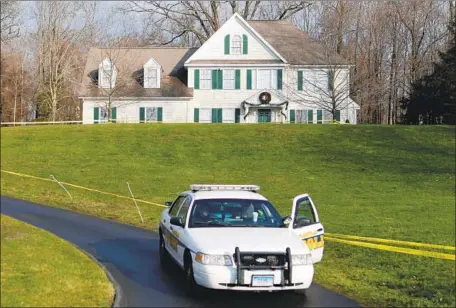 ?? Jason DeCrow Associated Press ?? POLICE SIT outside the Newtown, Conn., home where Adam Lanza shot his mother before killing 26 at Sandy Hook Elementary in 2012.