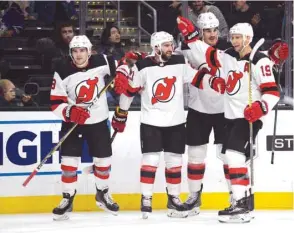  ?? PICTURE: USA TODAY Sports ?? New Jersey Devils right wing Kyle Palmieri (second left) celebrates with defenseman Will Butcher (left) centre Travis Zajac (right) and defenseman Ben Lovejoy his goal scored against the Los Angeles Kings during the first period at Staples Center.