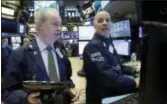  ?? RICHARD DREW — THE ASSOCIATED PRESS ?? Trader James Riley, left, and specialist John O’Hara work on the floor of the New York Stock Exchange, Friday. U.S. stocks edged higher Friday as gains from energy companies, industrial firms and smaller companies helped the market end a modest losing...