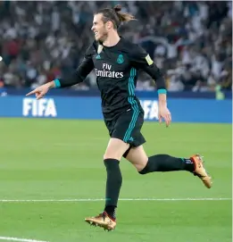  ??  ?? Real Madrid’s Gareth Bale celebrates after scoring in their Club World Cup match against Al Jazira Club in Abu Dhabi on Wednesday. Real won 2- 1. —