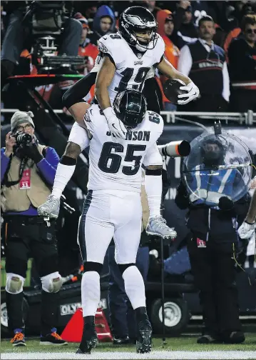  ?? — GETTY IMAGES ?? Philadelph­ia Eagles receiver Golden Tate (top) celebrates with Lane Johnson after scoring the go-ahead touchdown against the Chicago Bears yesterday.