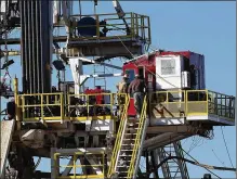  ?? SPENCER PLATT / GETTY IMAGES 2016 ?? Workers stand on the platform of a fracking rig in the Permian Basin oil field in Midland in January 2016, when crude oil plummeted below $27 a barrel. The price of West Texas intermedia­te crude is now above $65 a barrel.