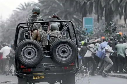  ?? PHOTO: REUTERS ?? Riot policemen attempt to disperse supporters of Kenya’s opposition National Super Alliance coalition during a protest in Nairobi.