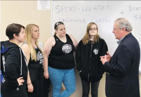  ?? JASON KRYK ?? From left, Border City Brawlers coach Justine Arbour, and team members Julia Valeriani, Becky Mathers and Leith Bergenhus speak with neuropsych­ologist and associate professor Dr. Joe Casey about the sports-related concussion program at the University...